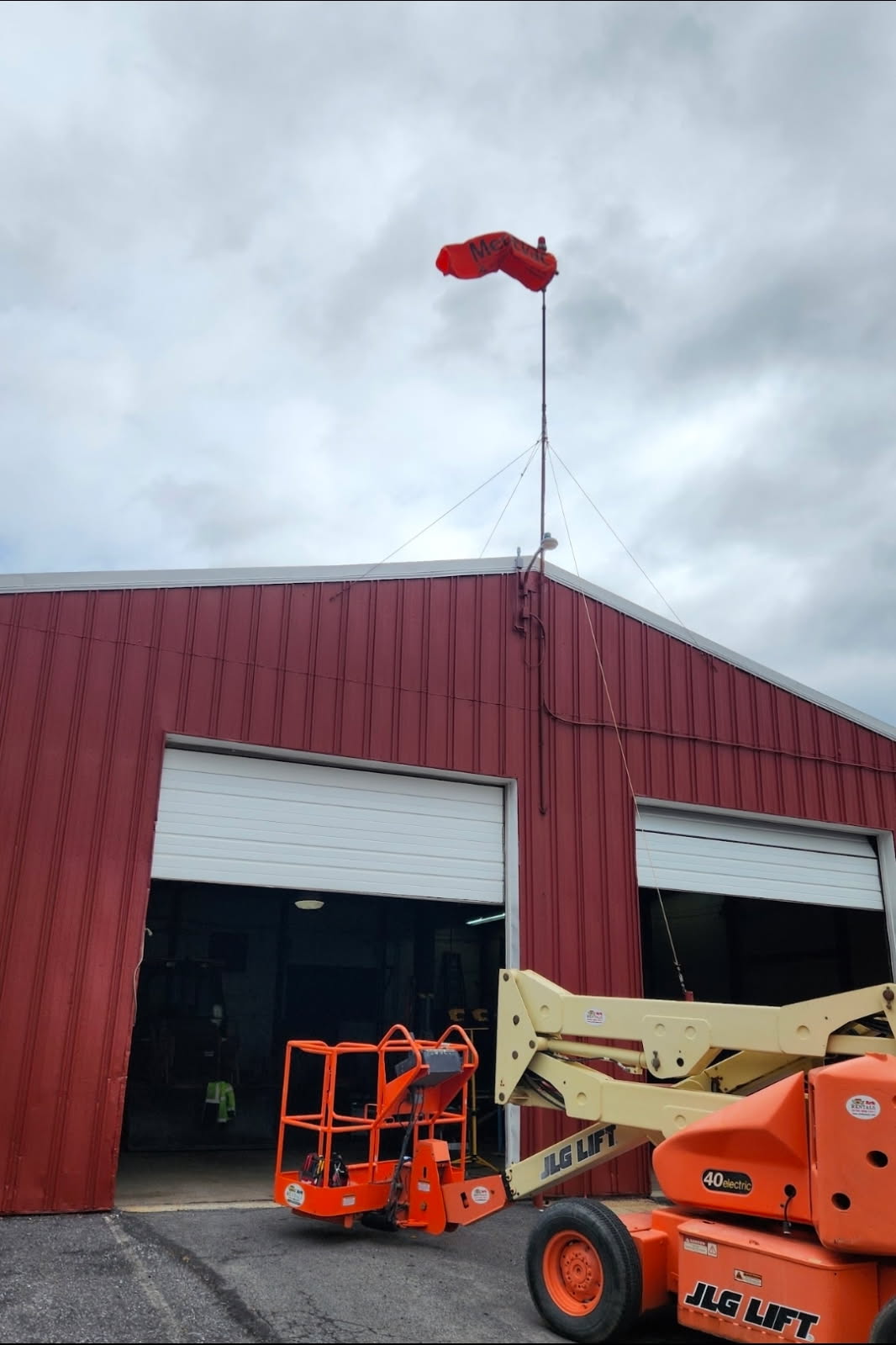 Lighted swiveling helicopter wind sock installed on a rooftop mast